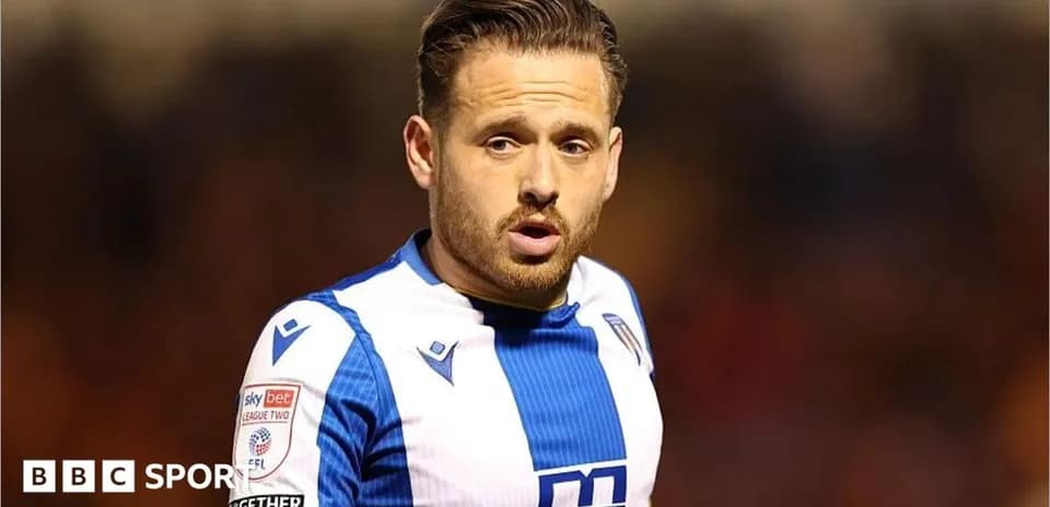 Football player in blue and white kit during match