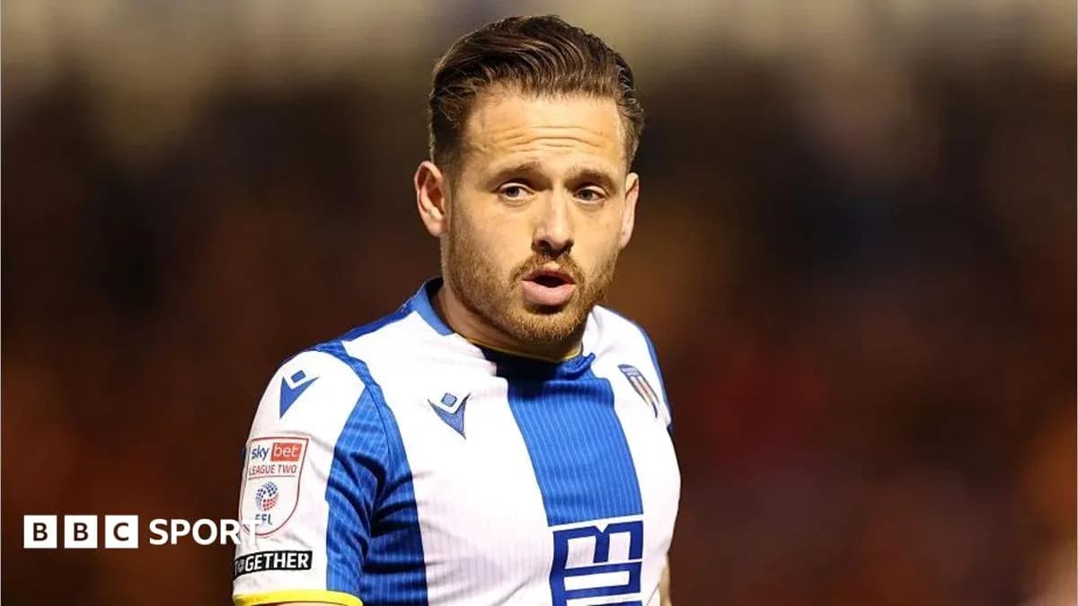 Football player in blue and white kit during match