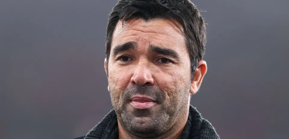 Man with short dark hair and beard speaking