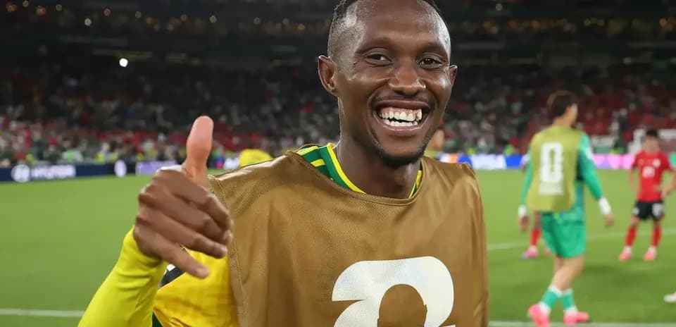 Player smiling and giving thumbs up on field