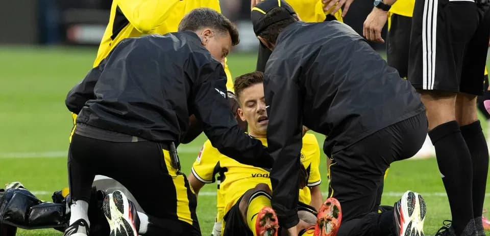 Medical team attending to injured player on field