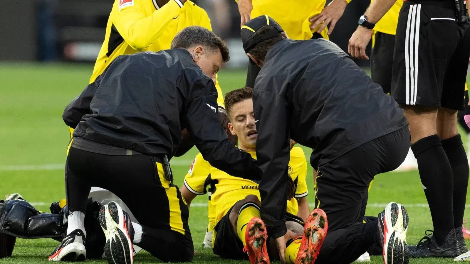 Medical team attending to injured player on field