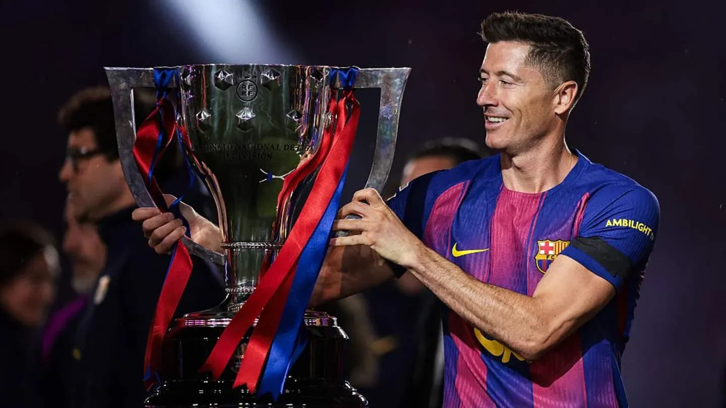 Player holding trophy during victory celebration Player holding trophy during victory celebration
