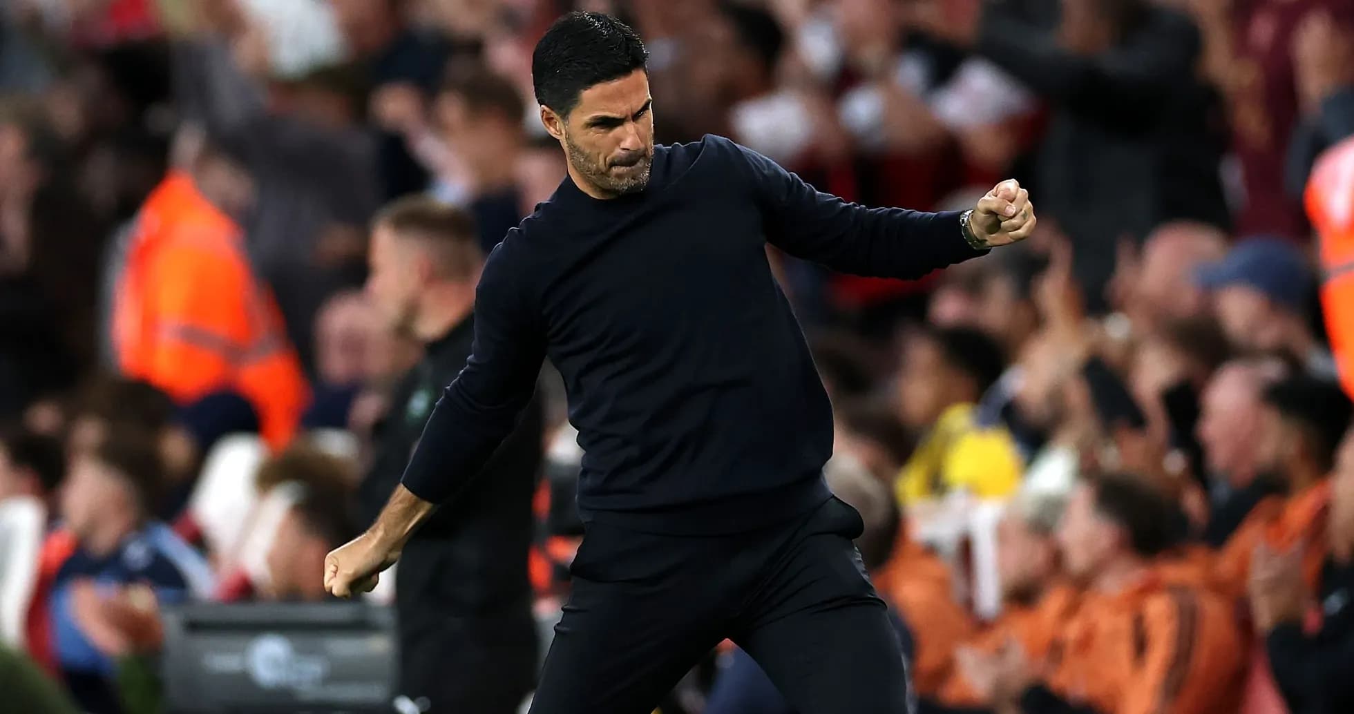 Manager celebrating during a match with fans Manager celebrating during a match with fans