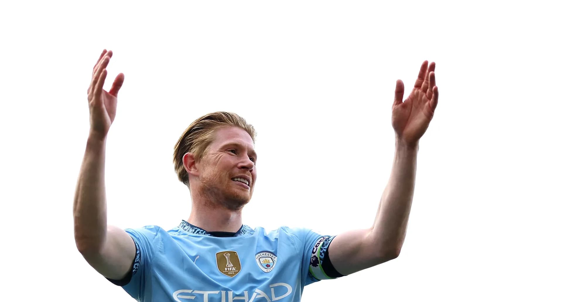 Player celebrating with arms raised on pitch Player celebrating with arms raised on pitch
