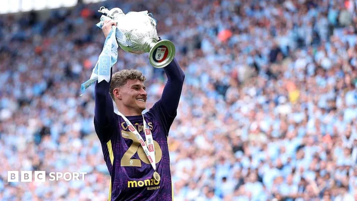 Player celebrating with trophy at victory ceremony Player celebrating with trophy at victory ceremony