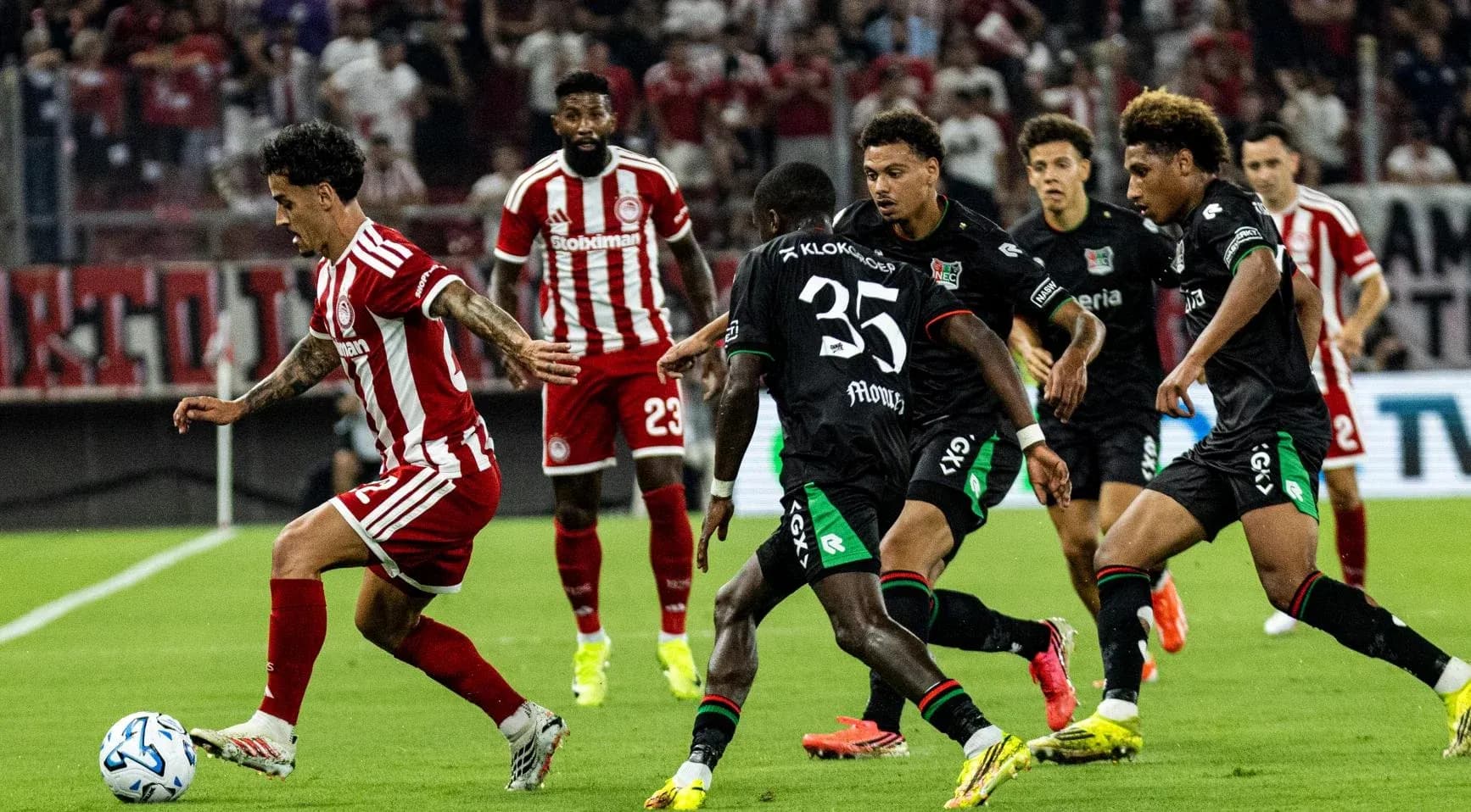 Olympiakos Piraeus player dribbling past NEC Nijmegen defenders Olympiakos Piraeus player dribbling past NEC Nijmegen defenders