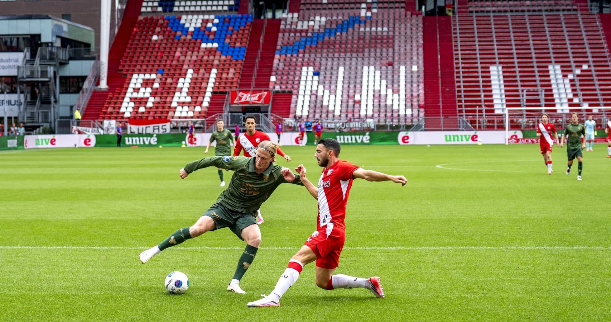 Player tackling opponent during a soccer match Player tackling opponent during a soccer match