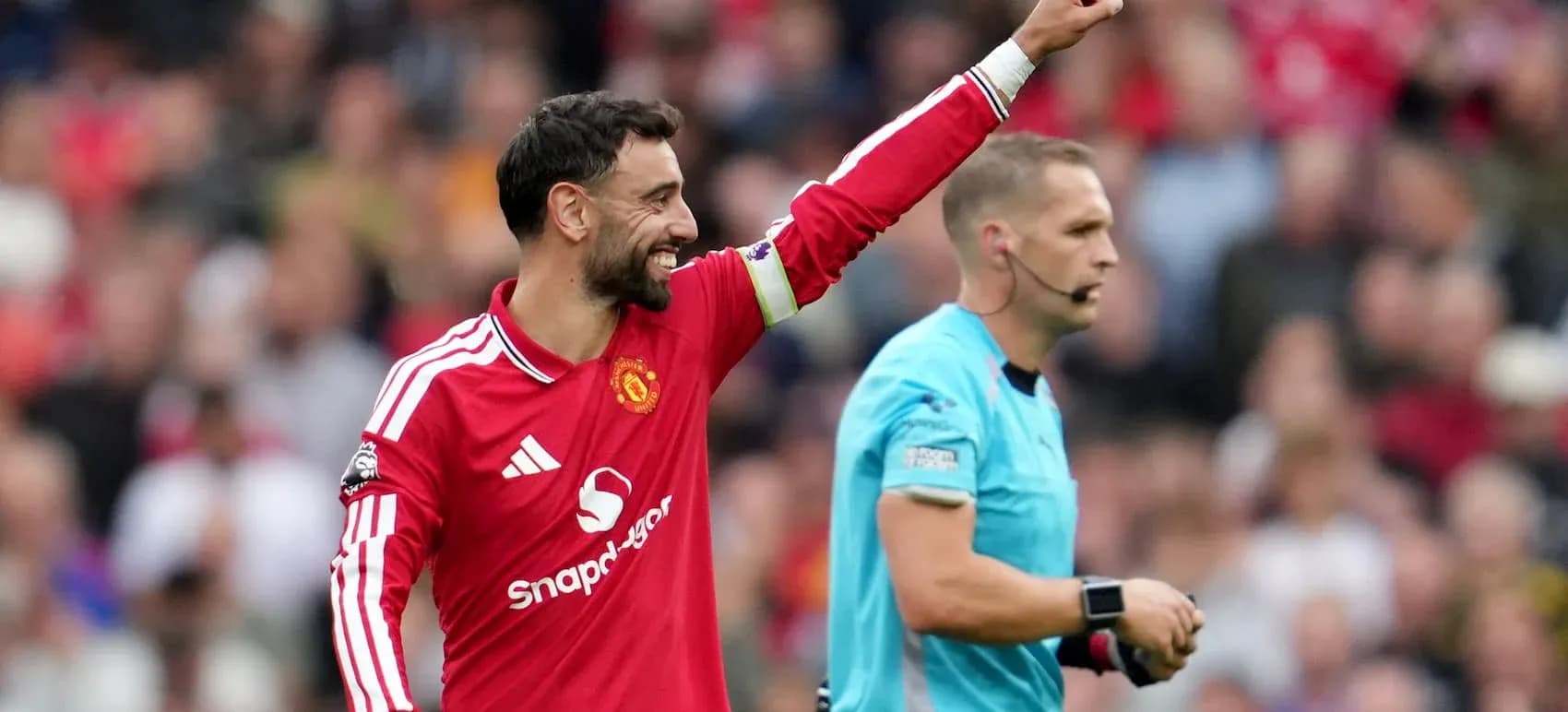 Bruno Fernandes celebrating with referee during match Bruno Fernandes celebrating with referee during match