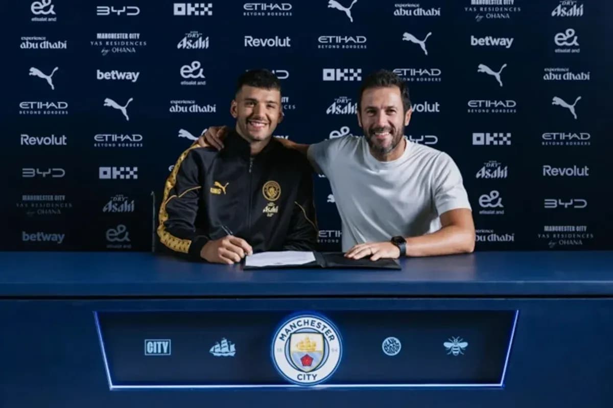 Player signing contract with manager at table Player signing contract with manager at table