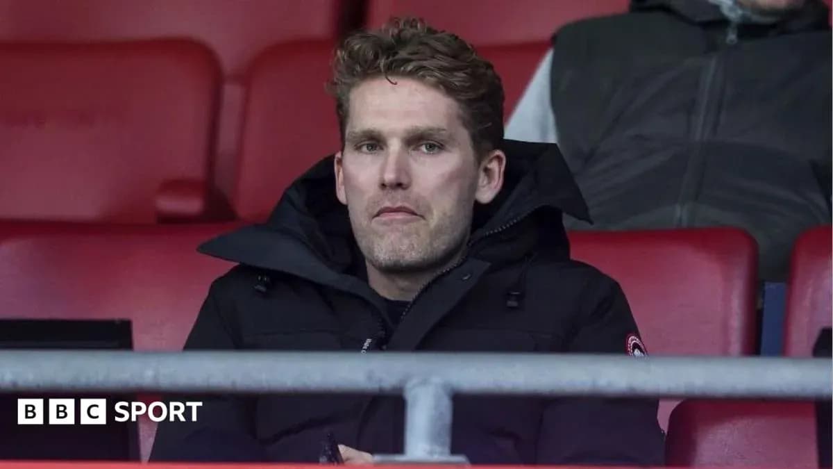 Man sitting in stadium seats during match Man sitting in stadium seats during match