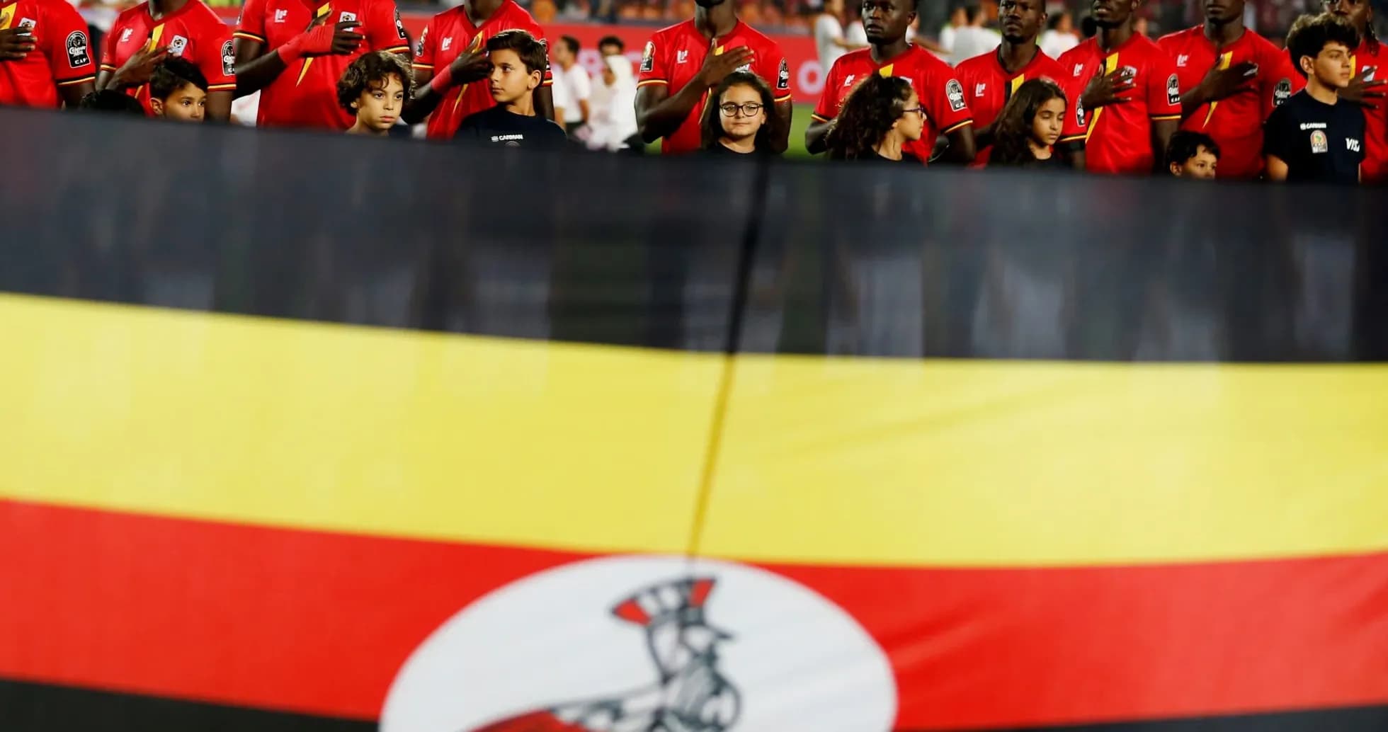 Ugandan team members standing before a match Ugandan team members standing before a match