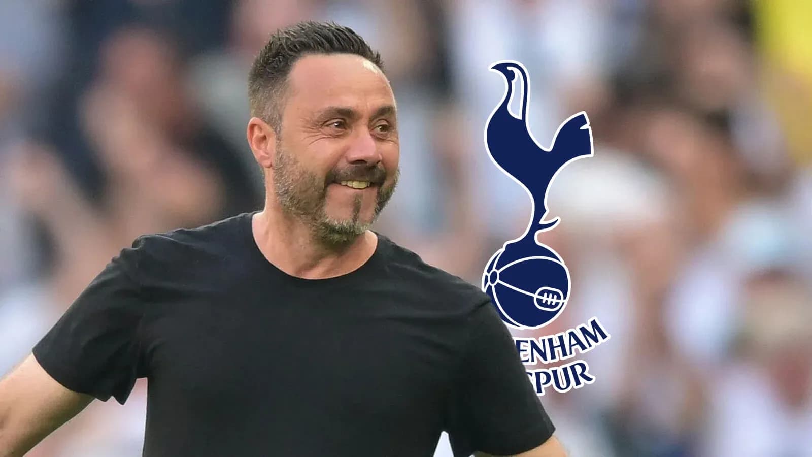 Manager smiling during match with Tottenham logo Manager smiling during match with Tottenham logo