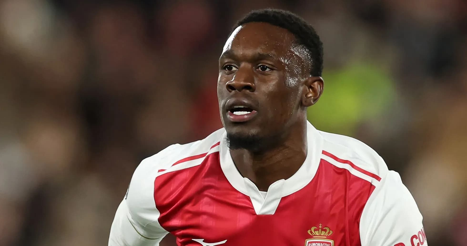 Player in AS Monaco kit running on the field Player in AS Monaco kit running on the field