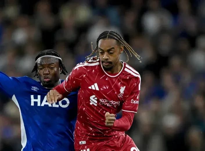 Liverpool player evading challenge from opponent Liverpool player evading challenge from opponent