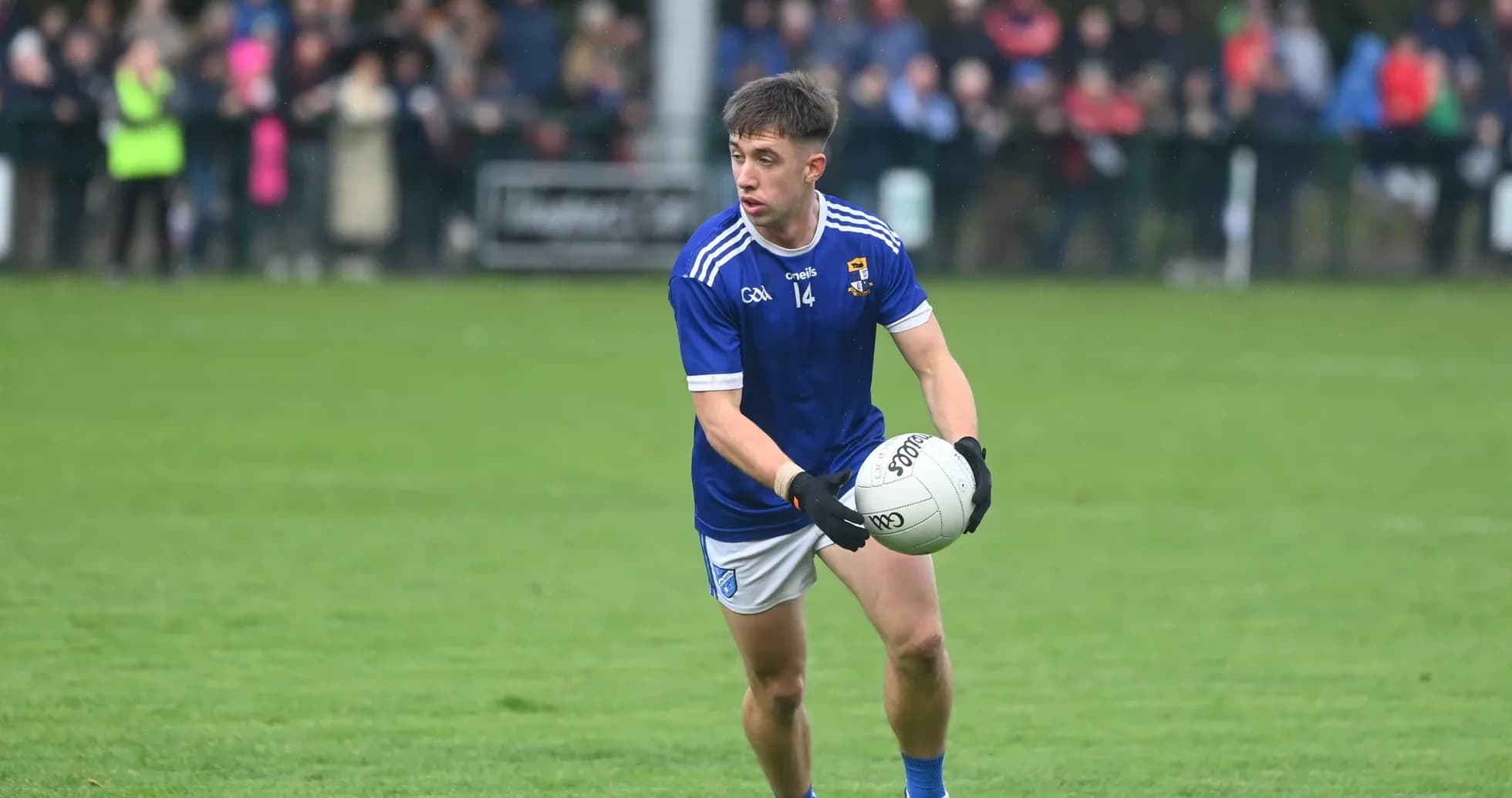 Player in blue jersey holding football during match Player in blue jersey holding football during match