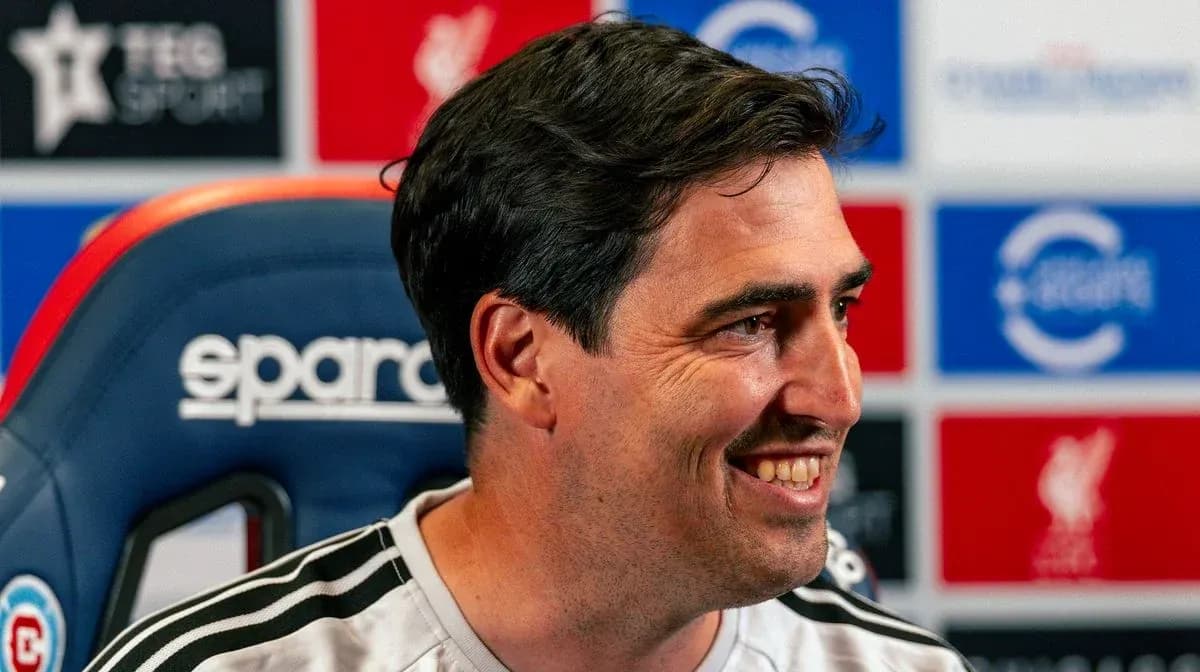 Coach smiling during press conference at podium Coach smiling during press conference at podium