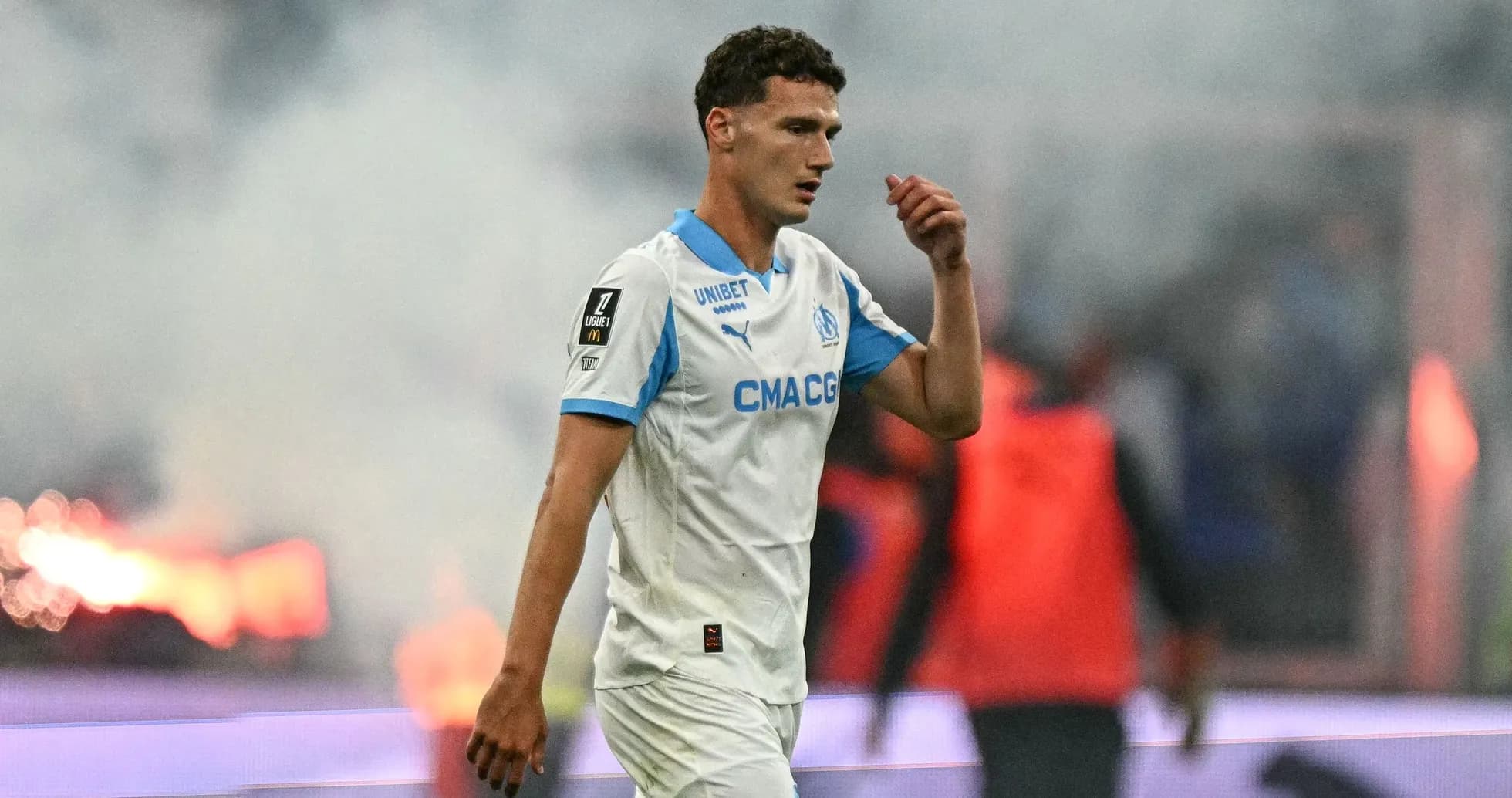 Player walking off field amid smoke during match Player walking off field amid smoke during match