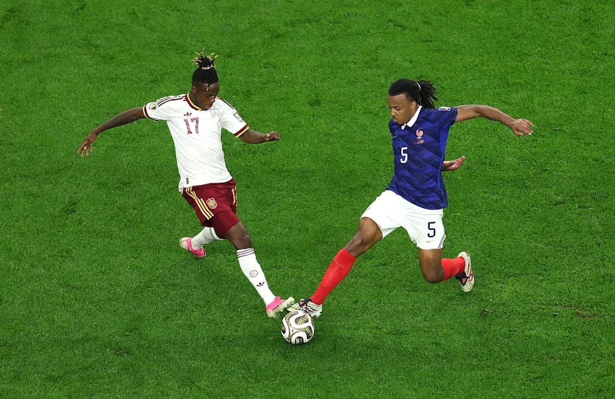Two players contesting the ball during a match Two players contesting the ball during a match