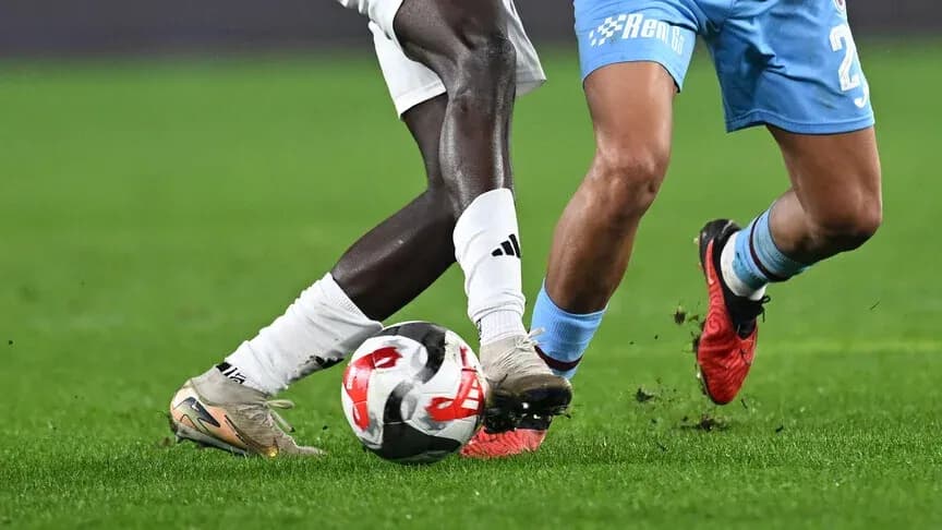 Two players challenging for the ball during match Two players challenging for the ball during match