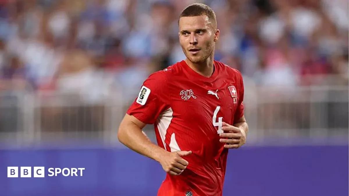 Swiss player wearing red jersey during match Swiss player wearing red jersey during match