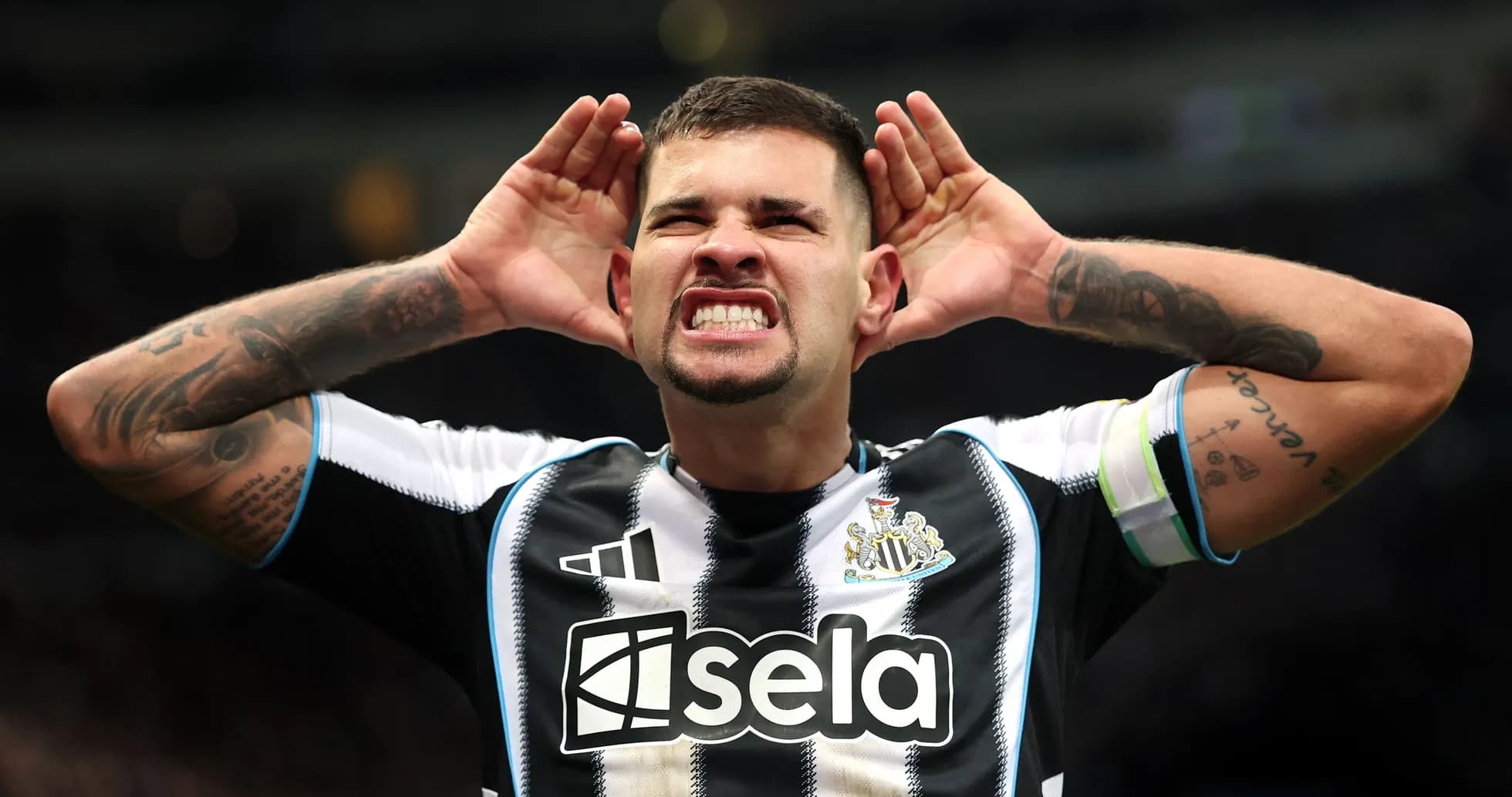 Player celebrating with hands on ears at stadium Player celebrating with hands on ears at stadium