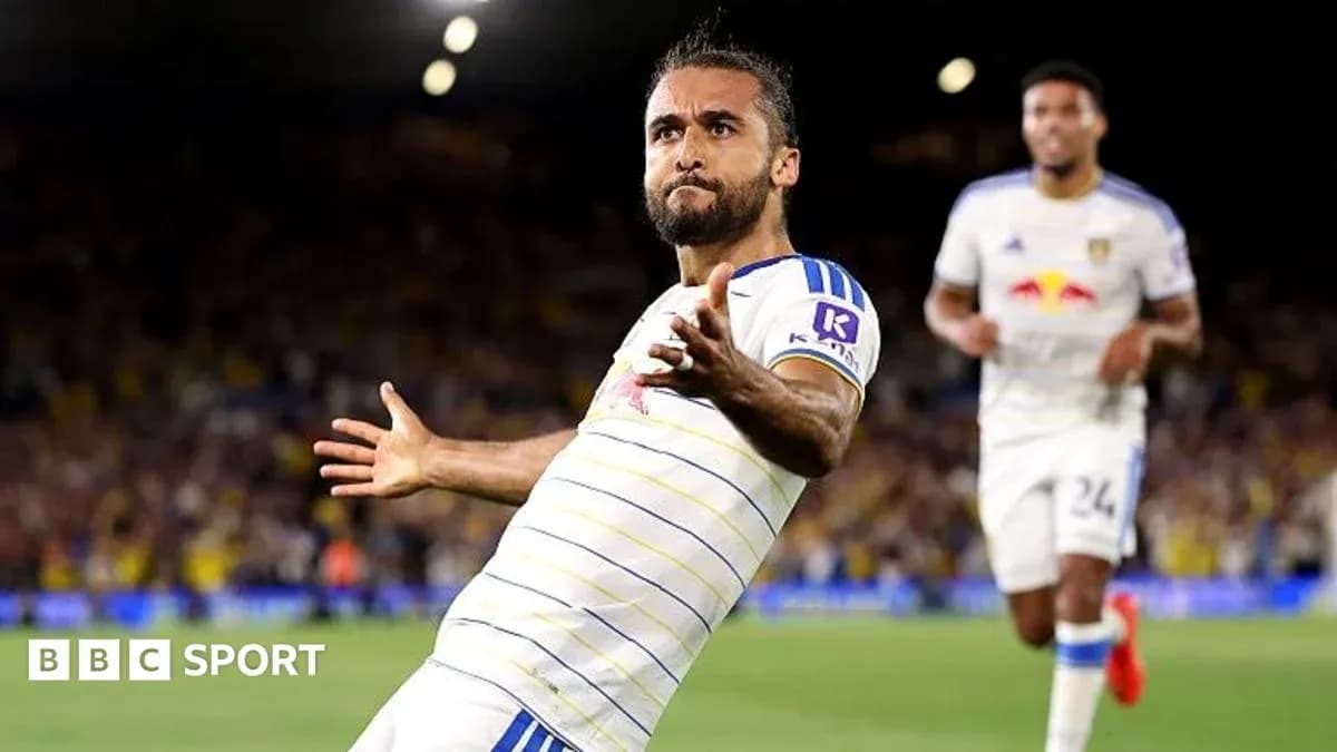 Player celebrating a goal with teammates in stadium Player celebrating a goal with teammates in stadium