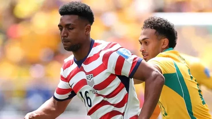 USA player dribbling past opponent during match USA player dribbling past opponent during match