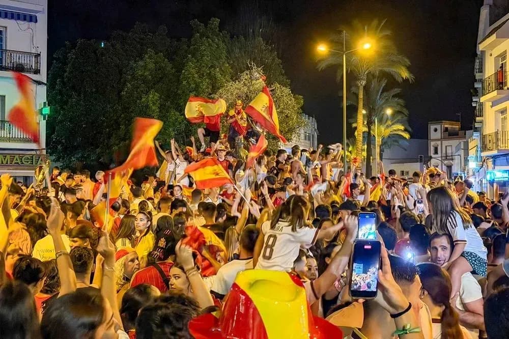 Crowd celebrating with Spanish flags at night Crowd celebrating with Spanish flags at night