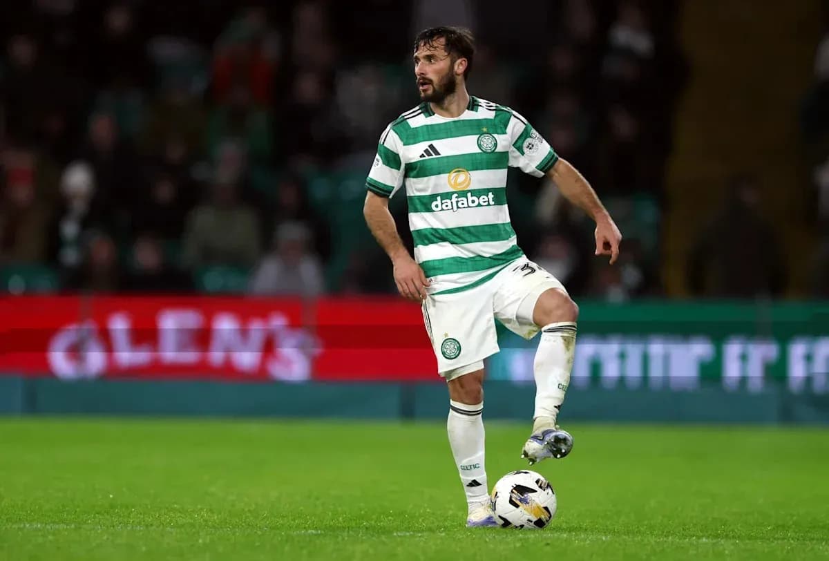 Player in Celtic kit controlling the ball on pitch Player in Celtic kit controlling the ball on pitch