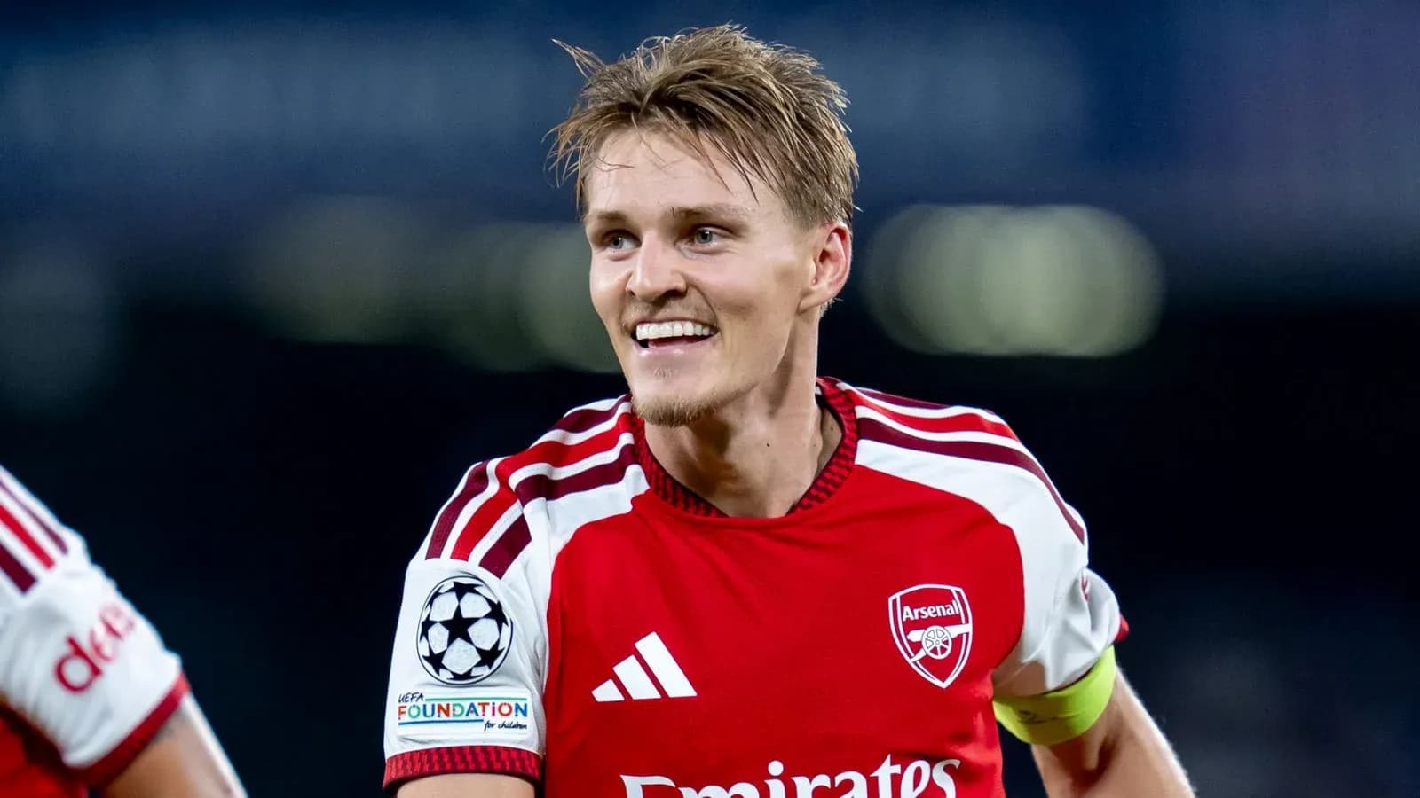 Player celebrating in Arsenal's red home kit Player celebrating in Arsenal's red home kit