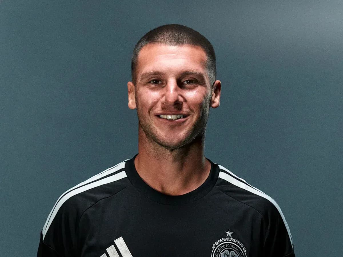Player posing in black jersey with logo Player posing in black jersey with logo