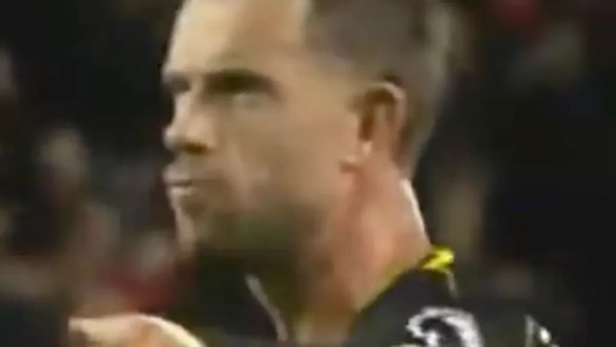Player in black uniform during a match Player in black uniform during a match
