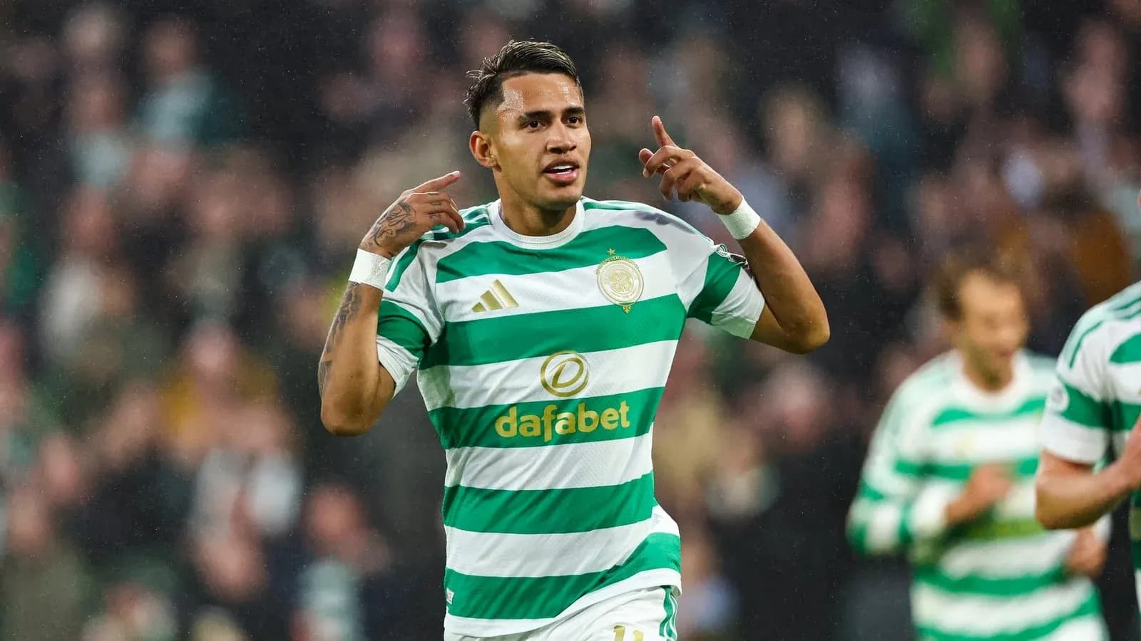 Celtic player celebrating a goal on the field Celtic player celebrating a goal on the field