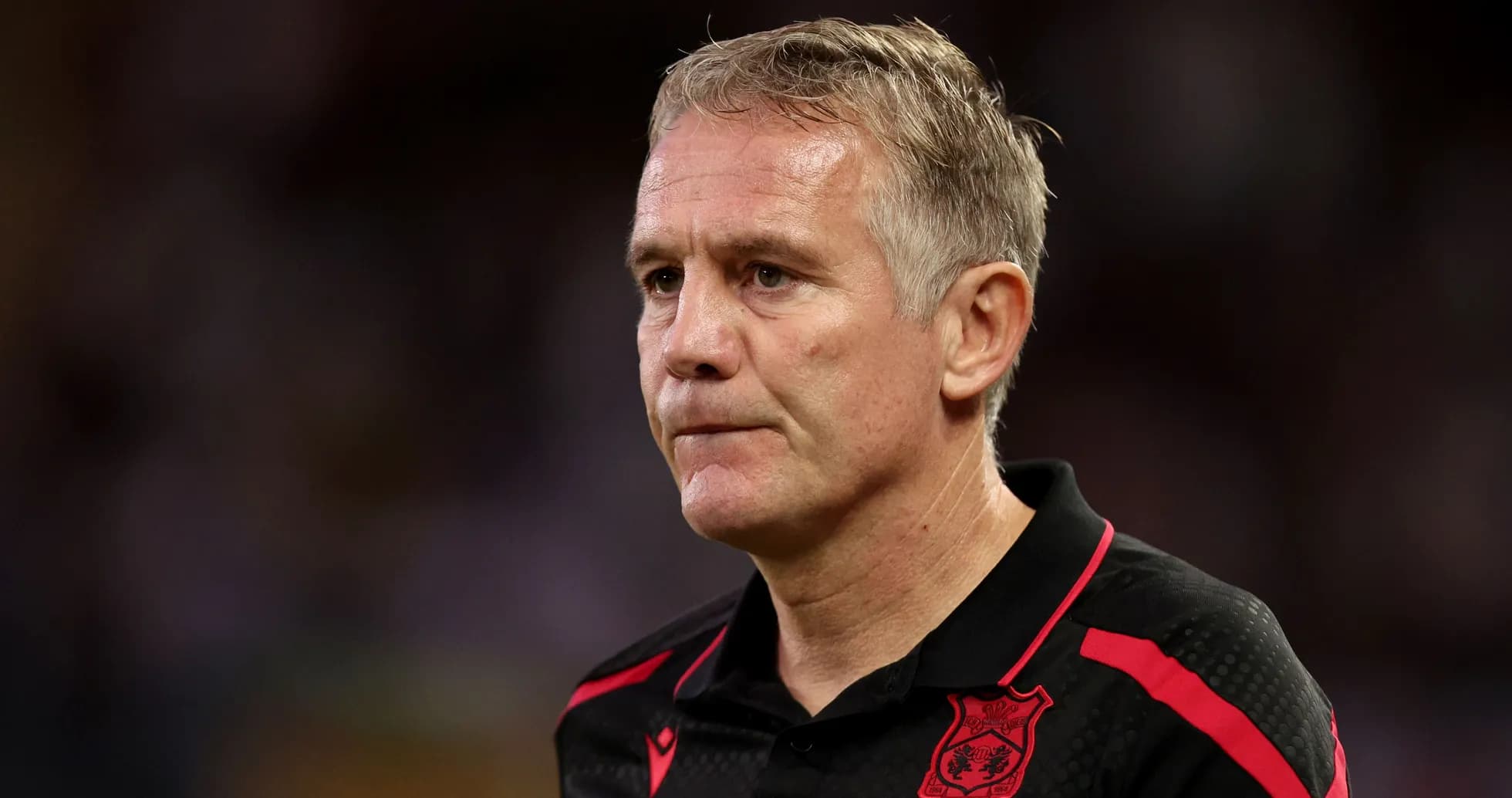 Coach in black and red shirt during match Coach in black and red shirt during match