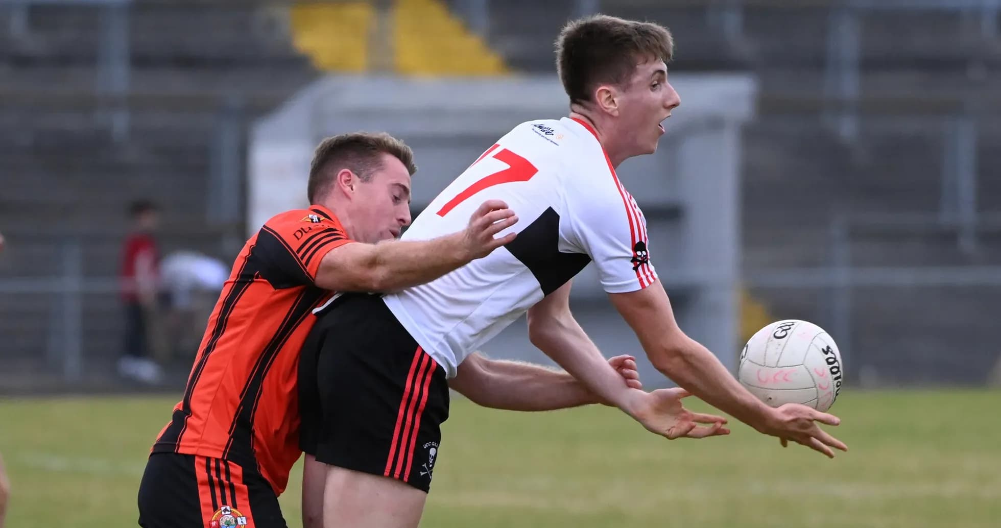 Player in black jersey tackling opponent with ball Player in black jersey tackling opponent with ball