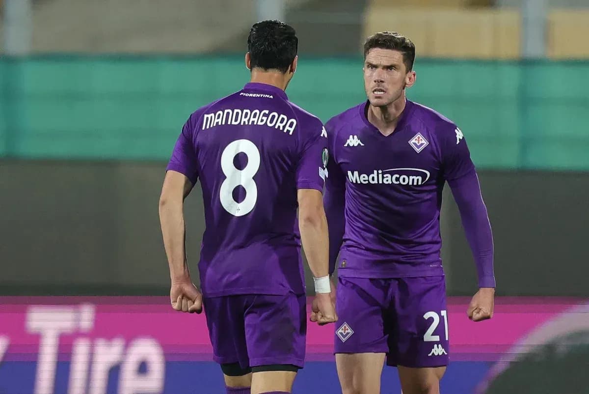 Two Fiorentina players celebrating on the pitch Two Fiorentina players celebrating on the pitch