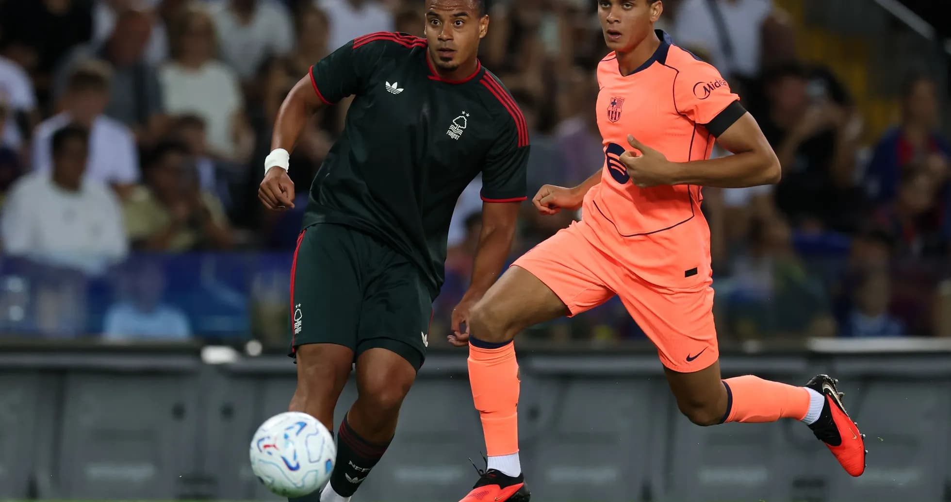 Two players competing for the ball during match Two players competing for the ball during match