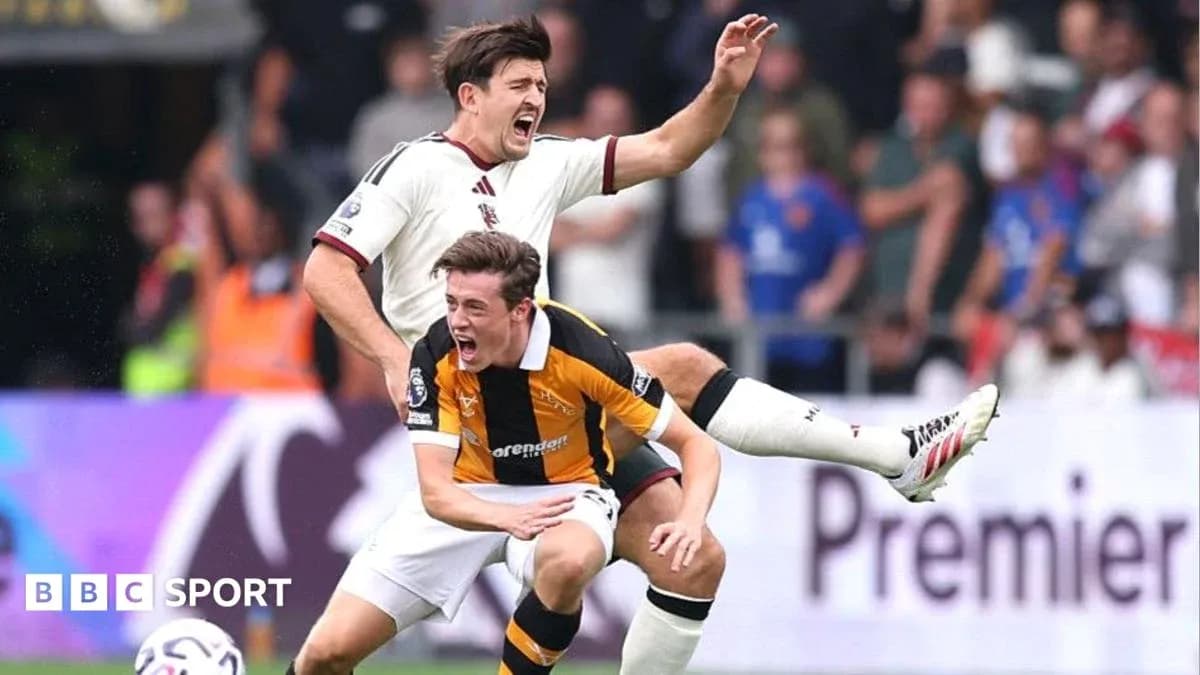 Two players in action during a football match Two players in action during a football match