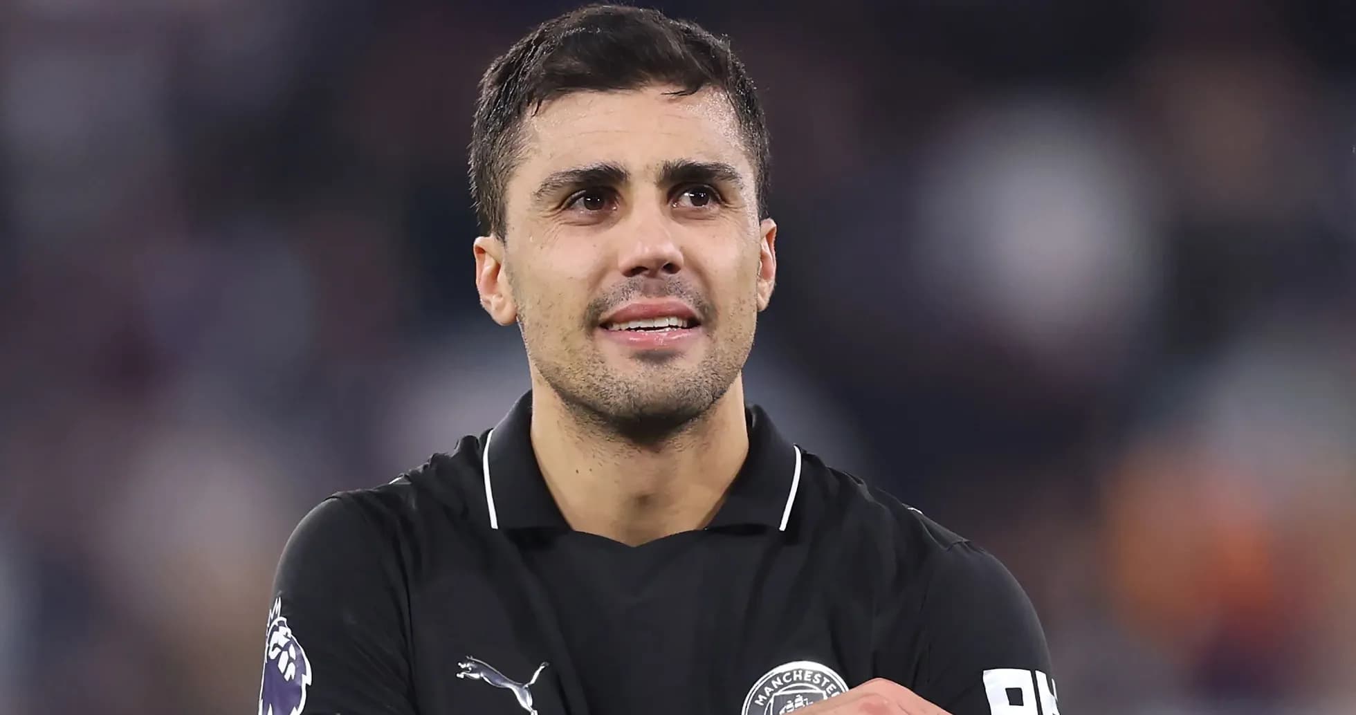 Player in black kit celebrating on the field Player in black kit celebrating on the field
