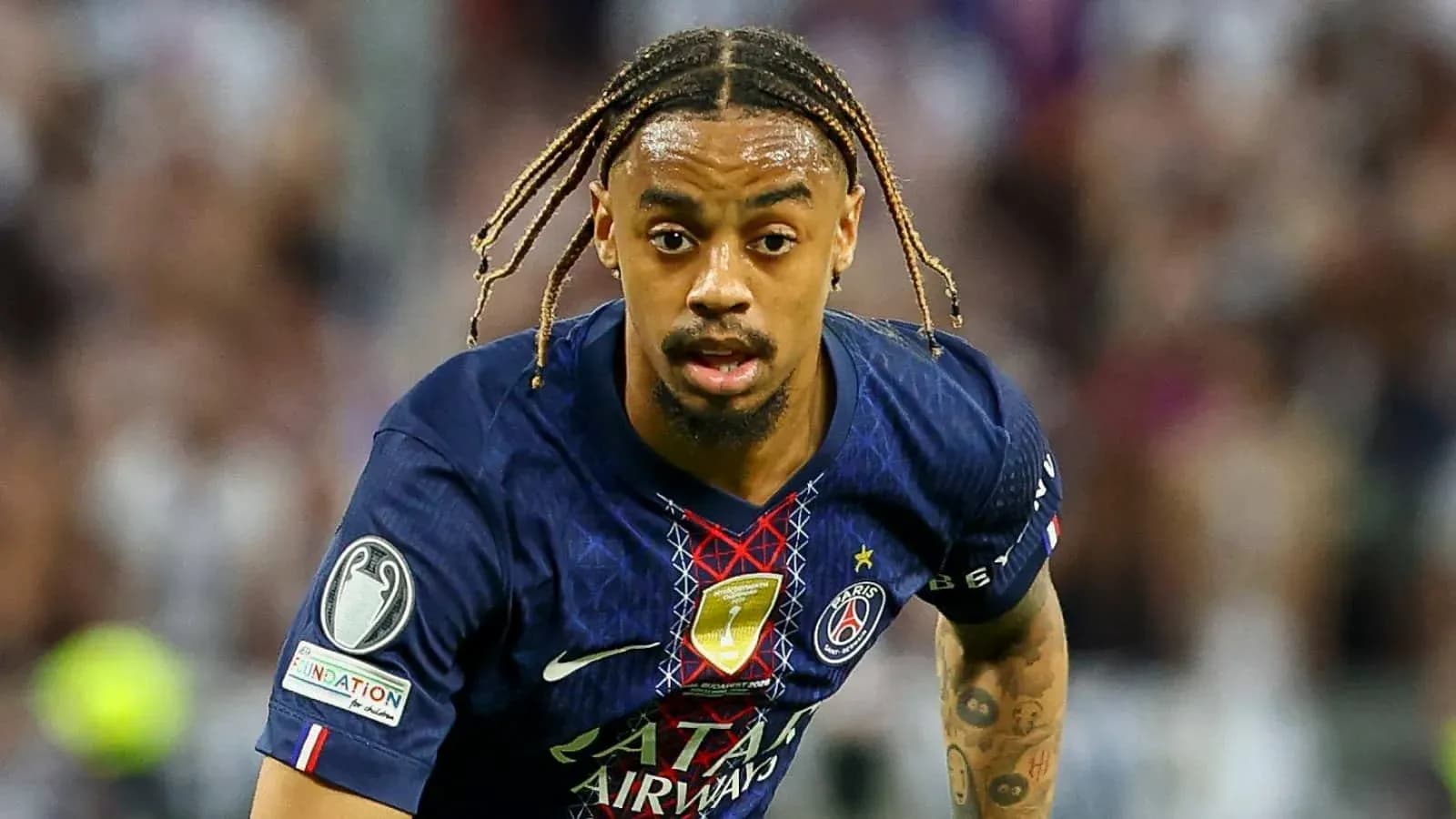 Player in PSG kit running during match action Player in PSG kit running during match action