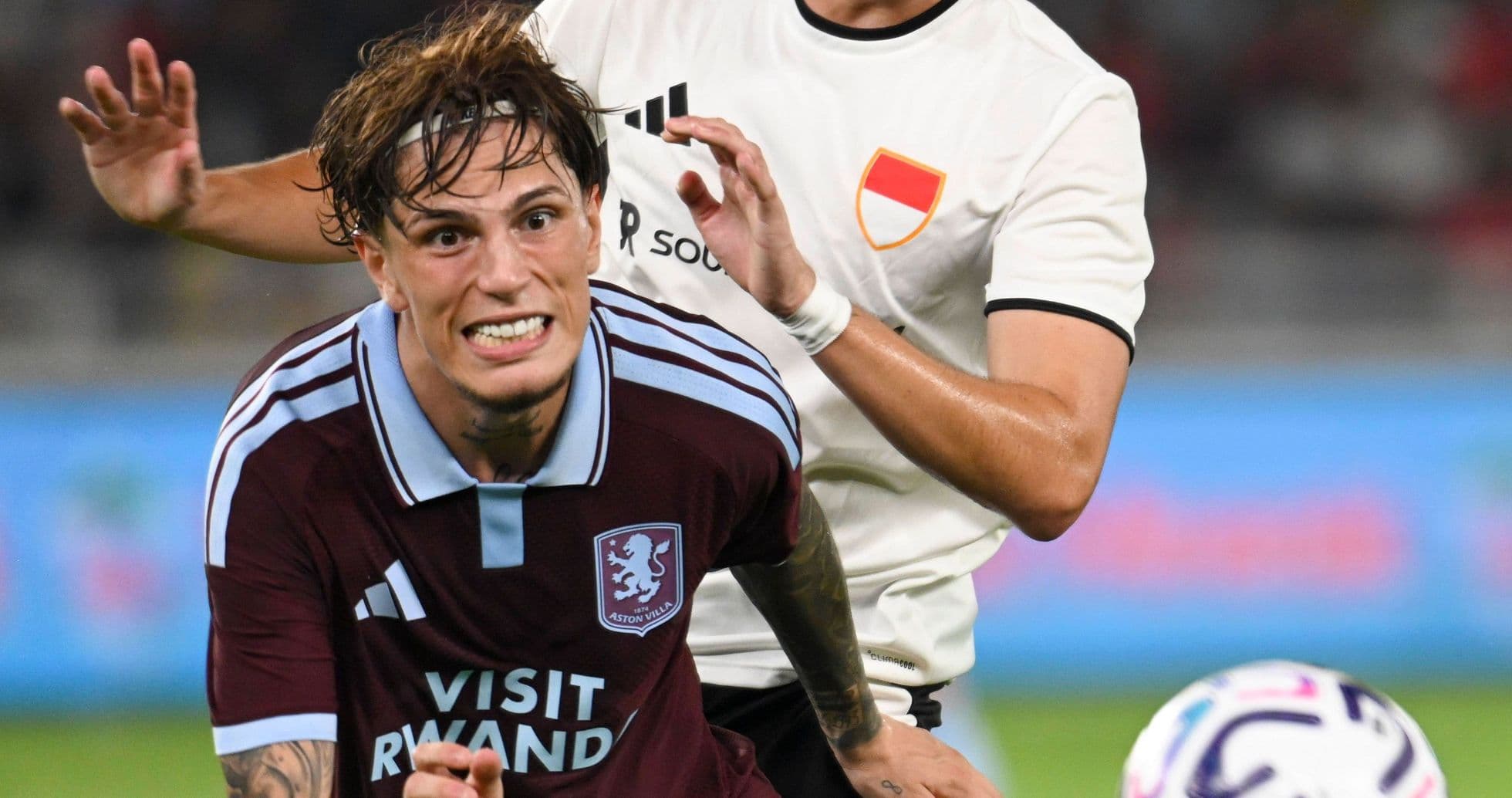 Aston Villa player being challenged by opponent Aston Villa player being challenged by opponent