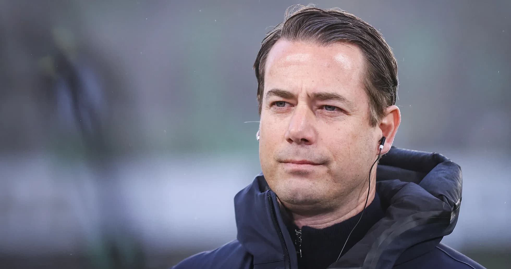 Coach wearing earpiece during match preparation Coach wearing earpiece during match preparation
