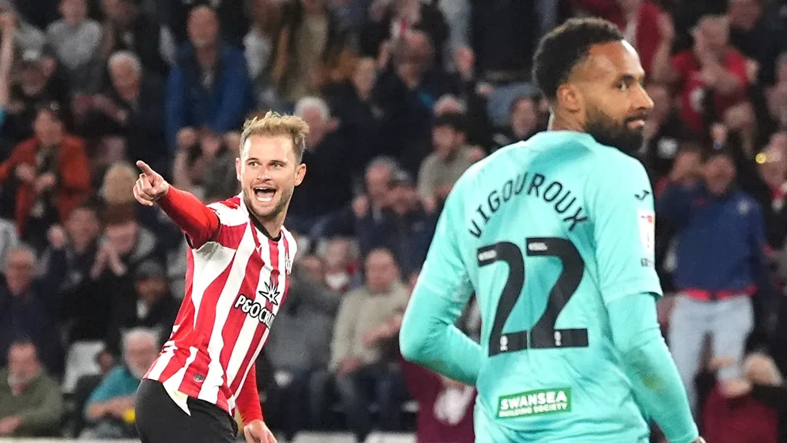 Player celebrating a goal with teammate in match Player celebrating a goal with teammate in match