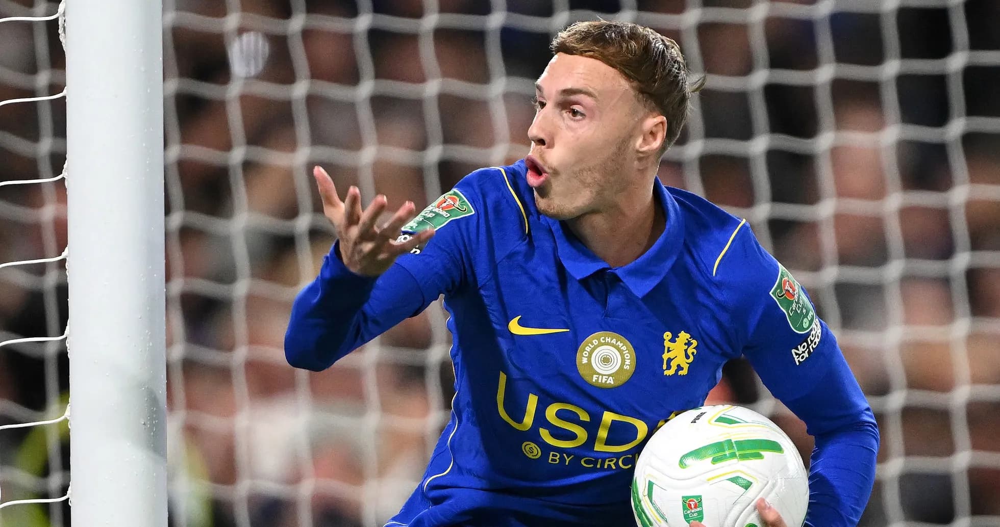 Goalkeeper gesturing while holding the ball during match Goalkeeper gesturing while holding the ball during match