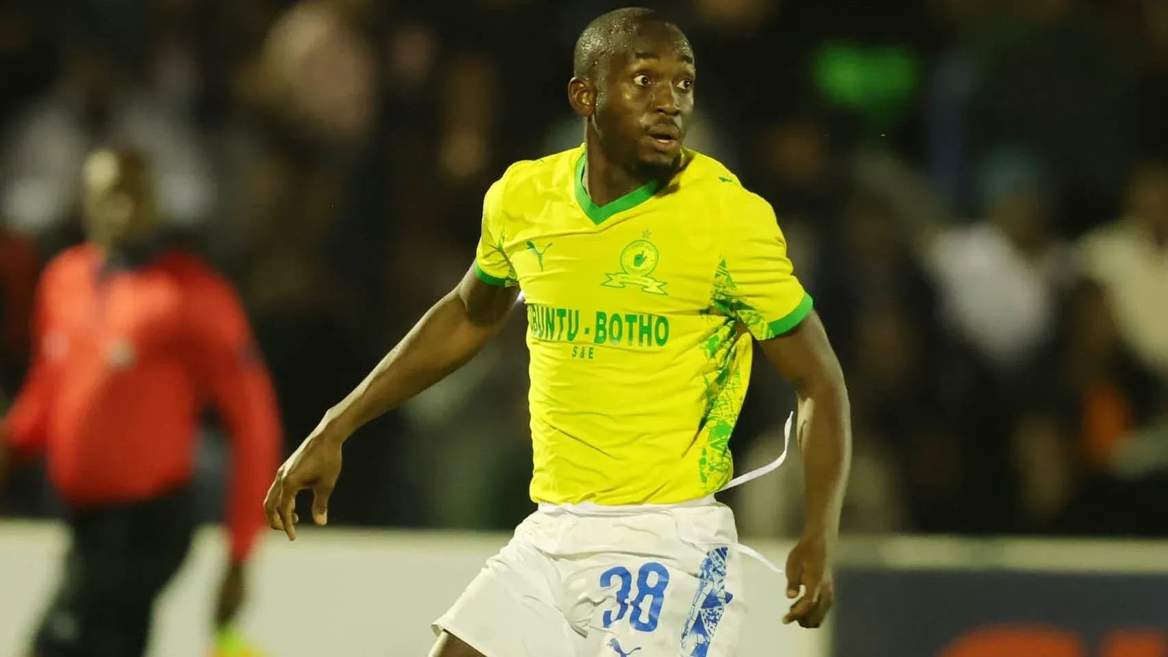 Player in yellow jersey during a match Player in yellow jersey during a match
