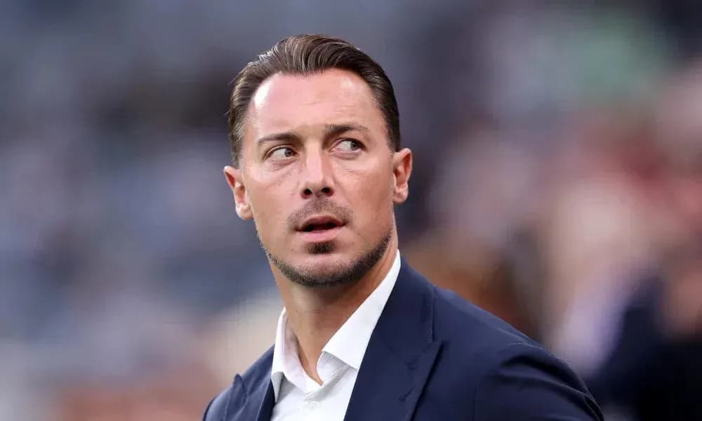 Man in suit looking away during a match Man in suit looking away during a match
