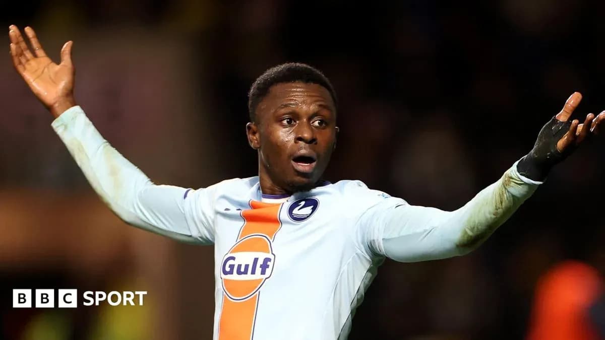 Player gesturing during a football match Player gesturing during a football match