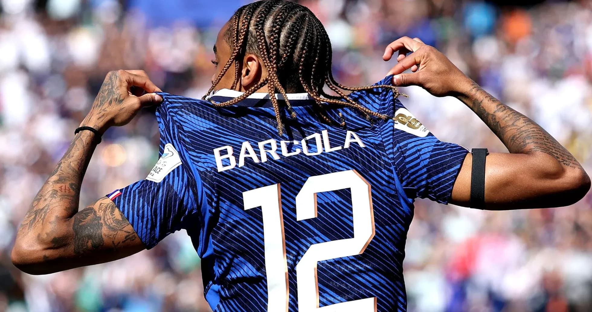 Player revealing jersey with name Barcola and number 12 Player revealing jersey with name Barcola and number 12