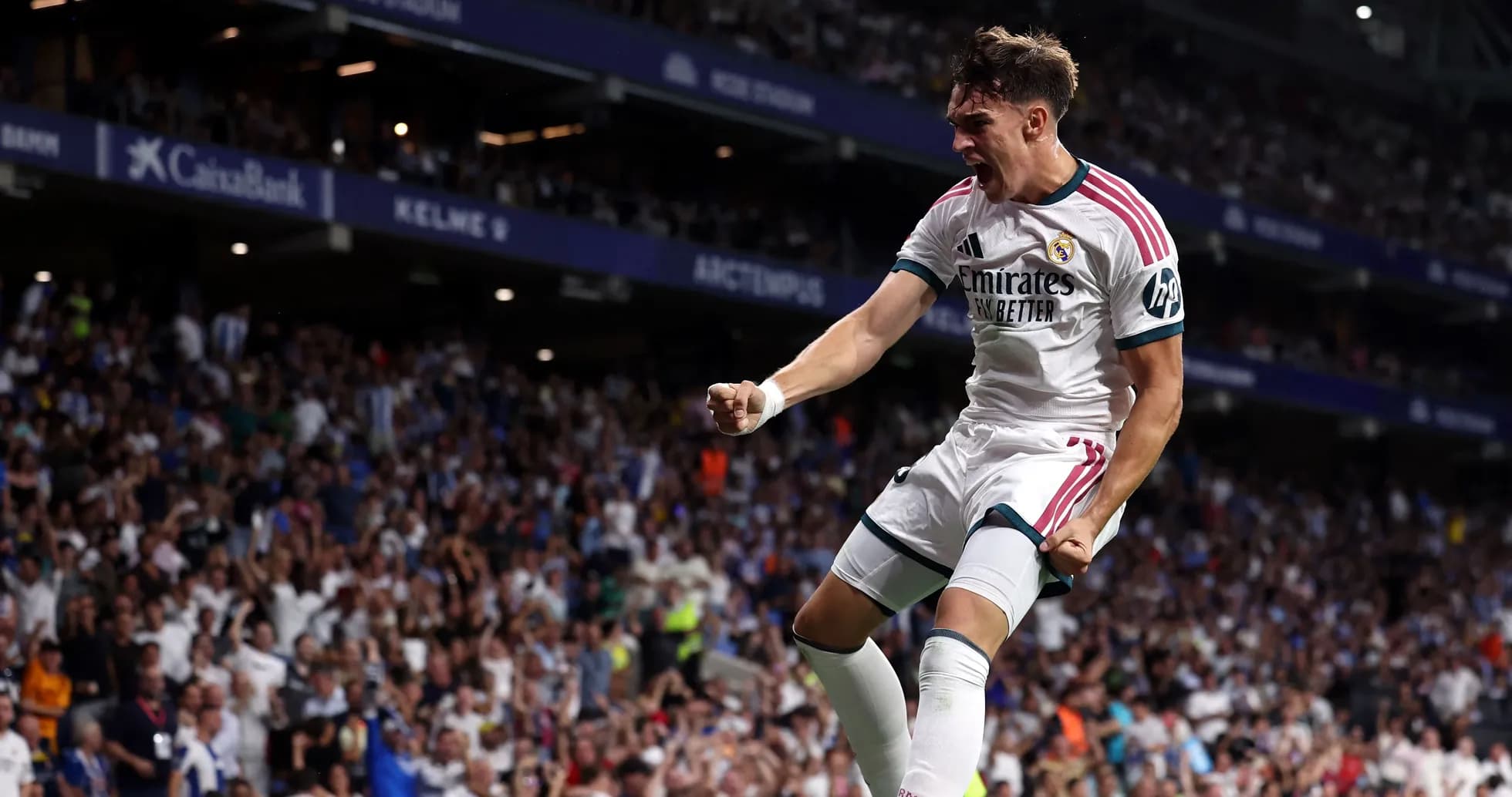 Player celebrating goal in front of cheering crowd Player celebrating goal in front of cheering crowd